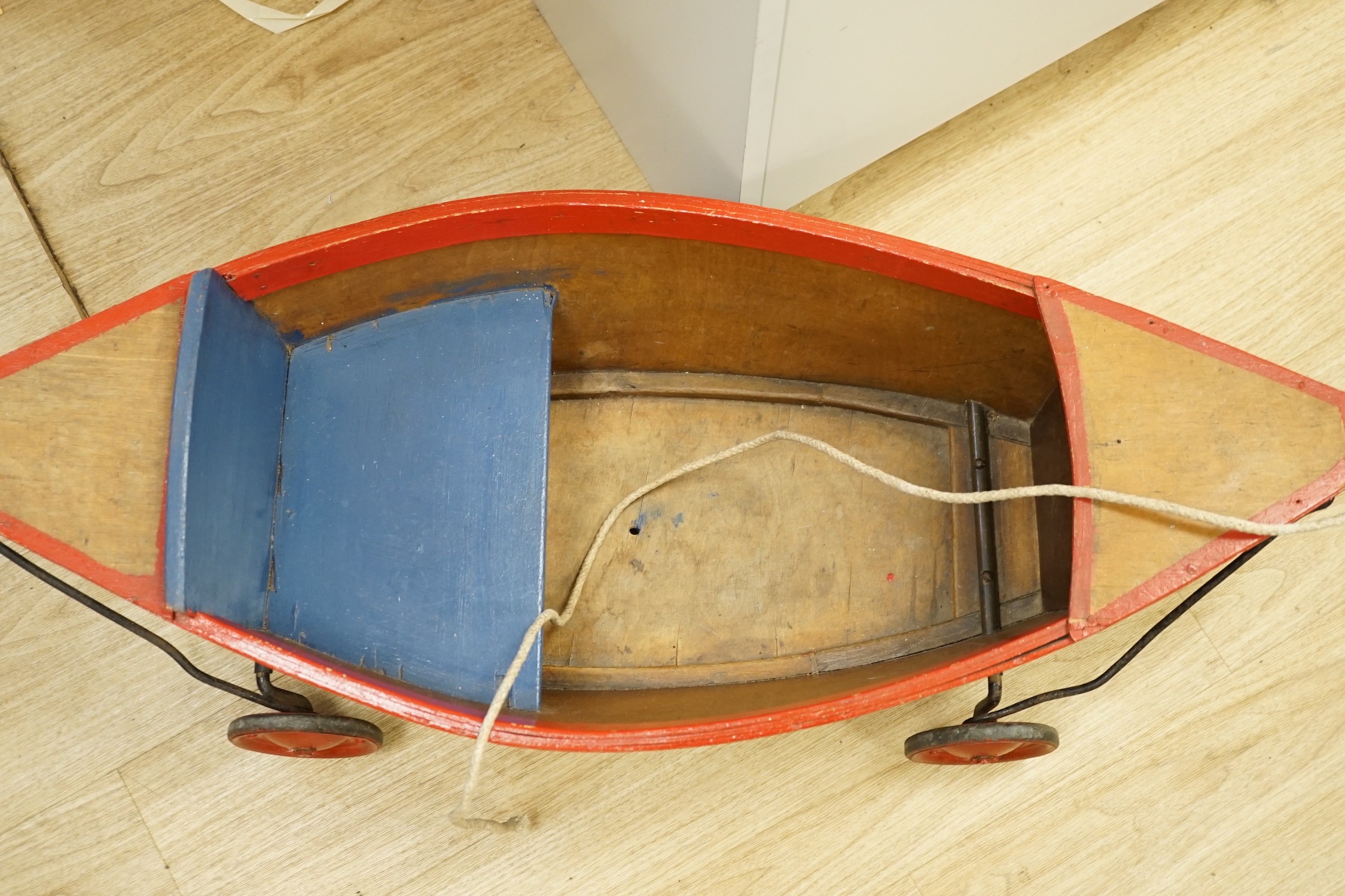 A 1930's Child's pull-along boat, on wheels, 96cms long